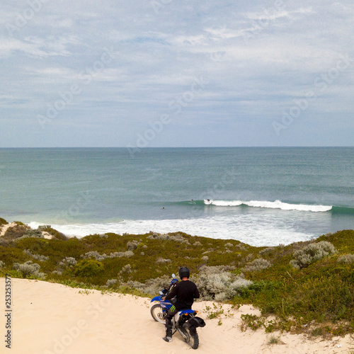 Motor cycle rider checking surf