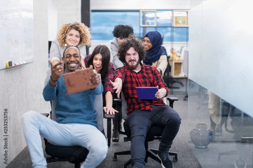 multiethnics business team racing on office chairs