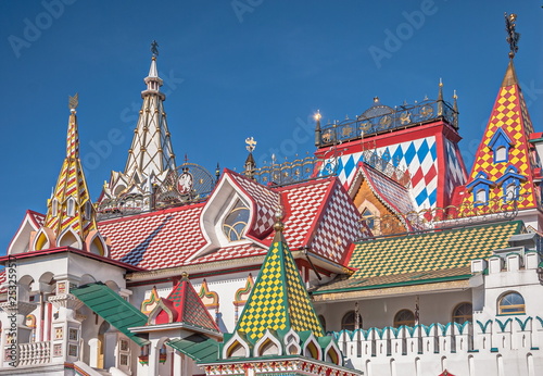 Bright painted tower with turrets, porches and weather vanes - sample of ancient Russian architecture