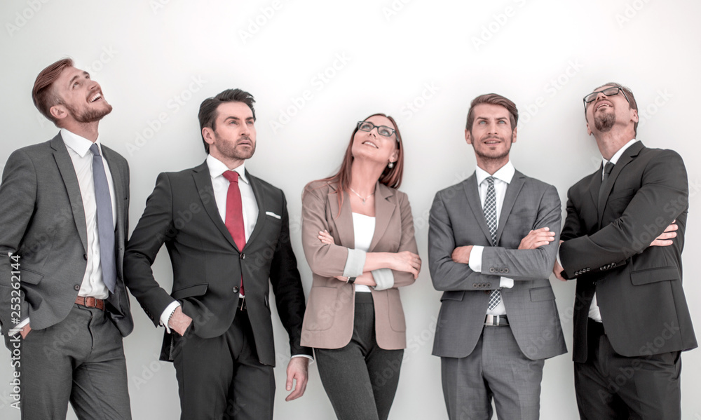 Happy positive business group looking up with dreaming expression Happy positive business group looking up with dreaming expression
