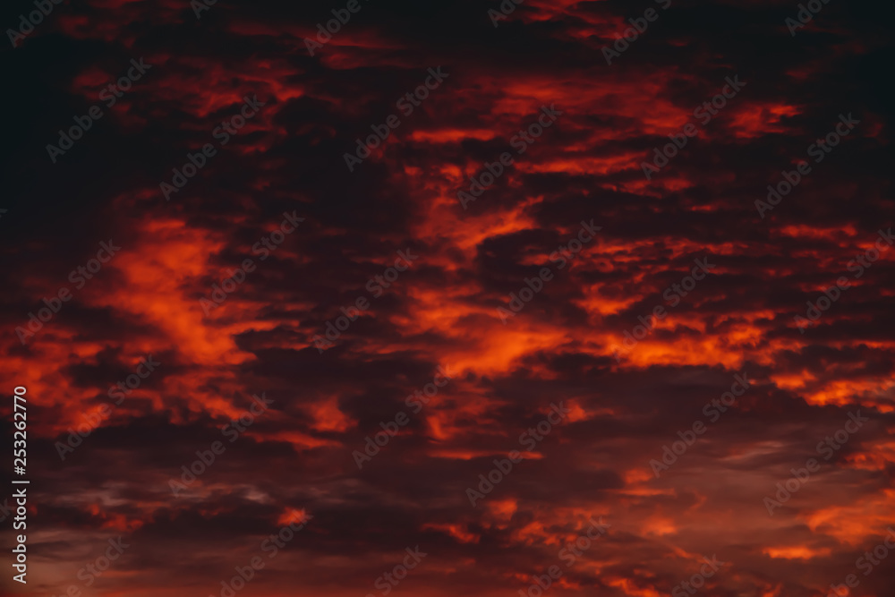 Fiery red blood vampire dawn. Amazing warm dramatic fire cloudy sky. Vivid orange sunlight. Atmospheric background of sunrise in overcast weather. Hard cloudiness. Storm clouds warning. Copy space. Fiery red blood vampire dawn. Amazing warm dramatic fire cloudy sky. Vivid orange sunlight. Atmospheric background of sunrise in overcast weather. Hard cloudiness. Storm clouds warning. Copy space.