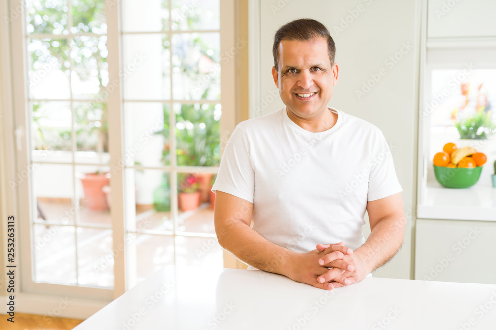 Middle age man smiling confident to the camera at home Middle age man smiling confident to the camera at home
