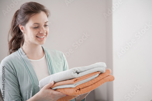  Pretty young woman housewife ironing clean washed things.