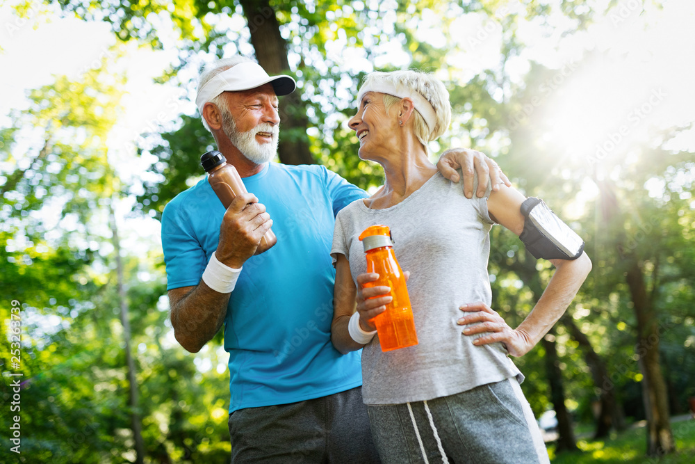 Fototapeta premium Happy fit senior couple exercising in park