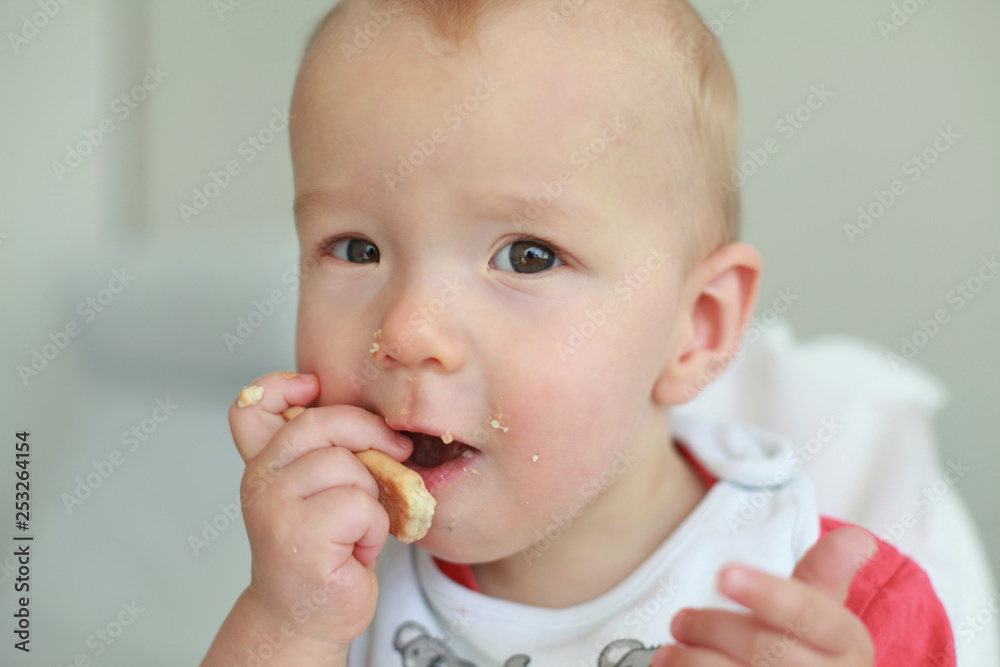 Cute little boy eating his first baby food Cute little boy eating his first baby food