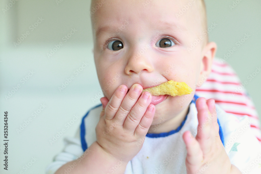 Cute little boy eating his first baby food Cute little boy eating his first baby food
