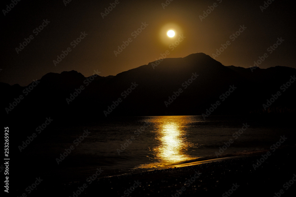Moon over the mountains. Bassa Beach. Khasab. Msandam. Oman