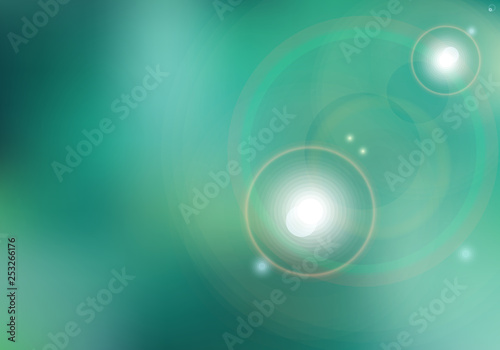Abstract sunset or sunrise and sun shining blurred green background with flare.