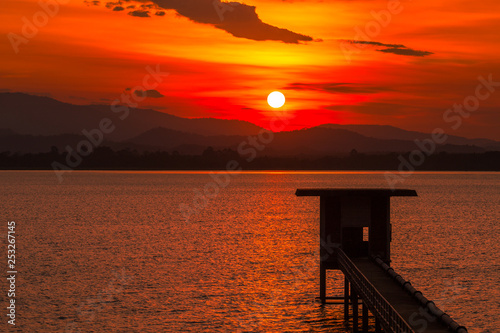 Close nature view Of the colorful sky (golden yellow) of the sun in the morning by the lake, behind the mountain, a beautiful journey