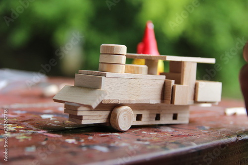 Child's hand, fold and stick a wooden toy
