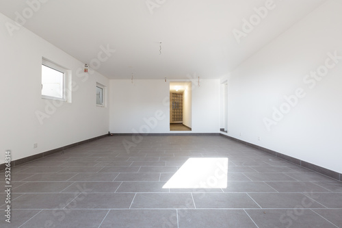 Cellar with gray tiles and white walls