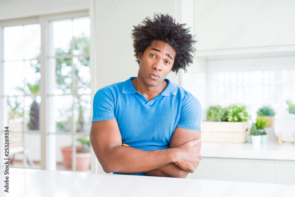 African American man at home skeptic and nervous, disapproving expression on face with crossed arms. Negative person. African American man at home skeptic and nervous, disapproving expression on face with crossed arms. Negative person.