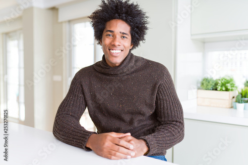 African American man wearing winter sweater with a happy and cool smile on face. Lucky person.