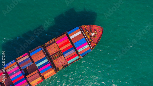 Container ship going to deep sea port, Business logistic import export shipping and transportation by container ship, Aerial view.