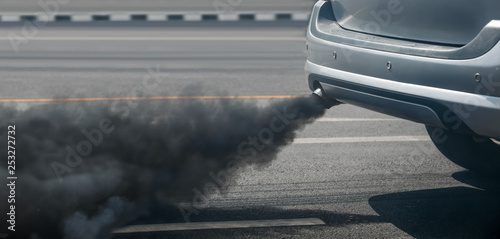 air pollution crisis in city from diesel vehicle exhaust pipe on road photo