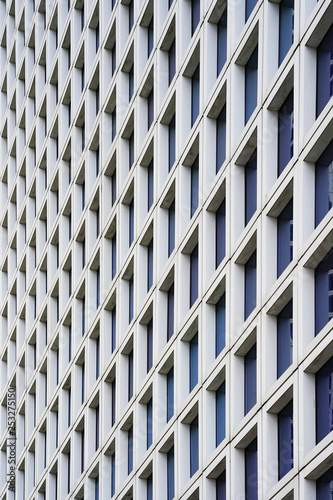 The outgoing perspective of the windows of the facade of a modern building. Glass grey square Windows of modern city business building skyscraper. Windows of a building, texture.