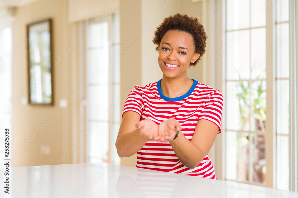 Young beautiful african american woman at home Smiling with hands palms together receiving or giving gesture. Hold and protection Young beautiful african american woman at home Smiling with hands palms together receiving or giving gesture. Hold and protection