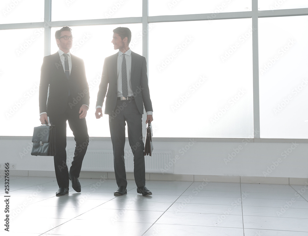 background image. two businessmen standing in the lobby of the office background image. two businessmen standing in the lobby of the office