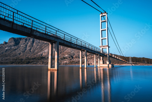 Fototapeta Naklejka Na Ścianę i Meble -  The longest suspension bridge in Bulgaria over Studen Kladenez dam with distance between the two towers of 260m. The only way to reach Lisicite village
