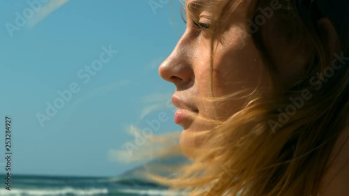 Close-up of a young Caucasian woman relaxing on the beach 4k