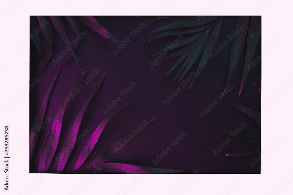 Tropical and palm leaves in vibrant bold gradient holographic neon colors , background.