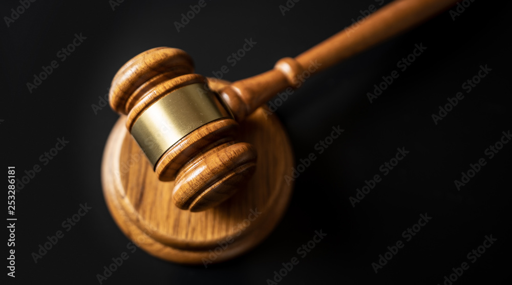 judge or auction Gavel on a wood block in courtroom, dark background judge or auction Gavel on a wood block in courtroom, dark background