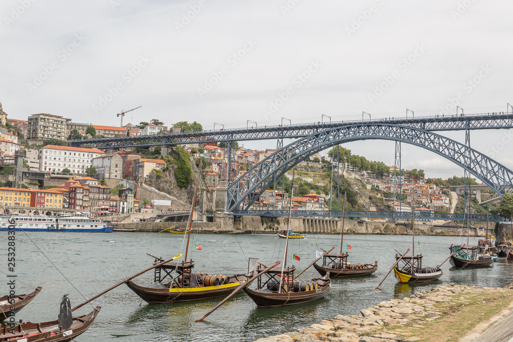 Old Porto cityscape skyline, traditional boats with wine barrels and Douro River in Porto