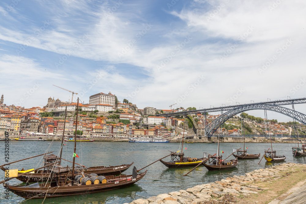 Porto, Portugal old town cityscape on the Douro River with traditional Rabelo boats
