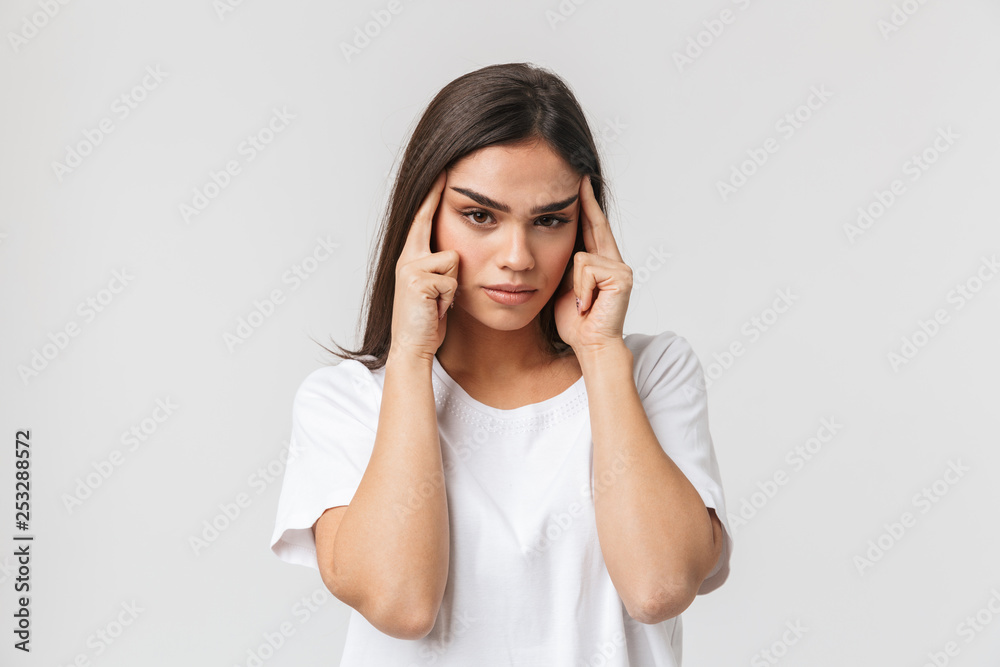 Upset young girl suffering from a headache Upset young girl suffering from a headache