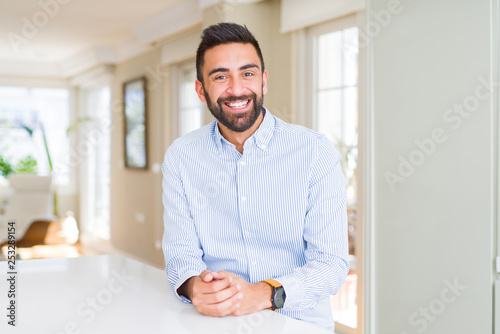 Handsome hispanic business man with a happy and cool smile on face. Lucky person.