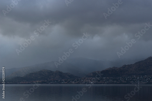 Beautiful reflections of clouds and mountains in the water of a lake