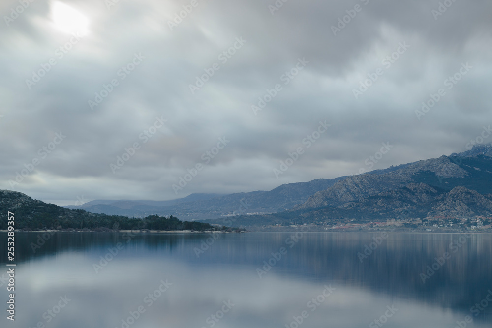 Beautiful reflections of clouds and mountains in the water of a lake