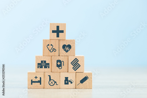 Health Insurance Concept,hand arranging wood block stacking with icon healthcare medical.