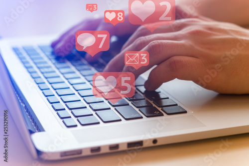 Man is using laptop with black keys, Social media and social networking. Marketing concept