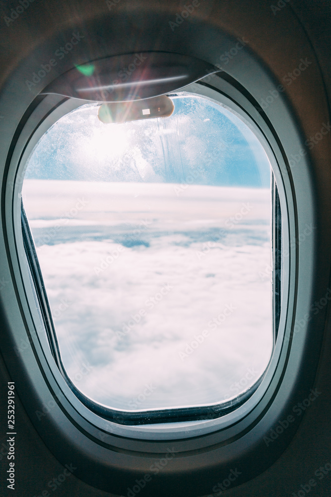 plane window with blue sunny sky view