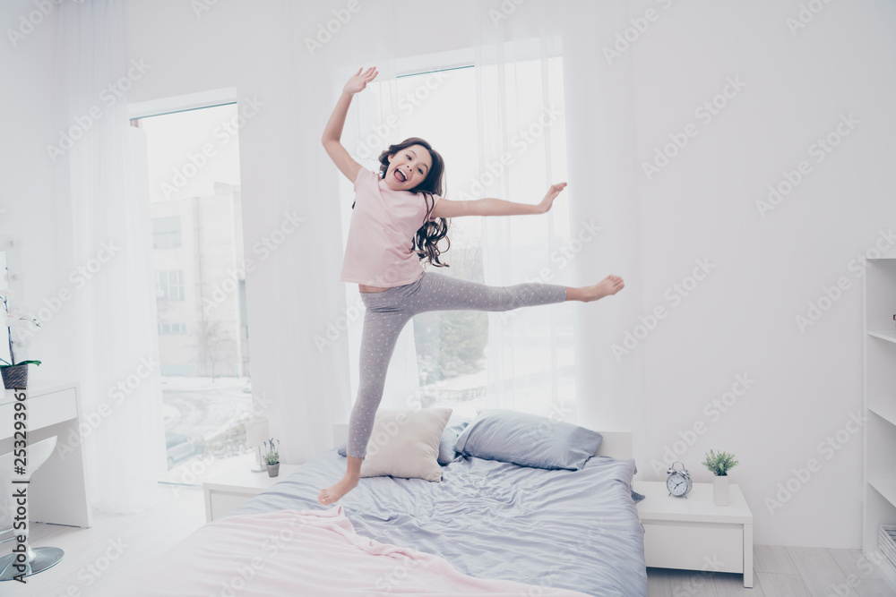 Full length body size view photo funky careless she her little girl jumping high on bed ballet figures flexible playful wear home t-shirt pants comfortable apartments flat bright light colored room