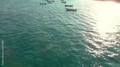 Small panga style dive boats on the ocean near shore in Tulum, Mexico. photo