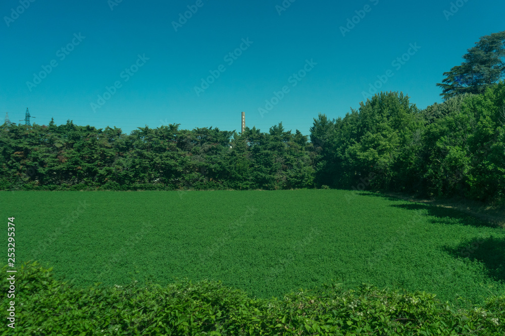 Italy,La Spezia to Kasltelruth train, a large green field with trees in the background