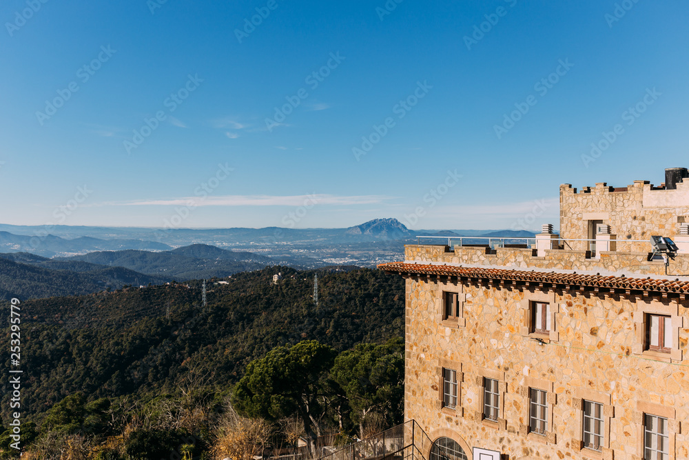 old castle and beautiful view of hills covered with forest, barcelona, spain
