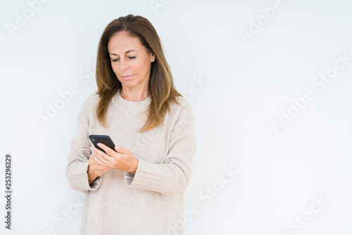 Middle age woman using smartphone over isolated background with a confident expression on smart face thinking serious