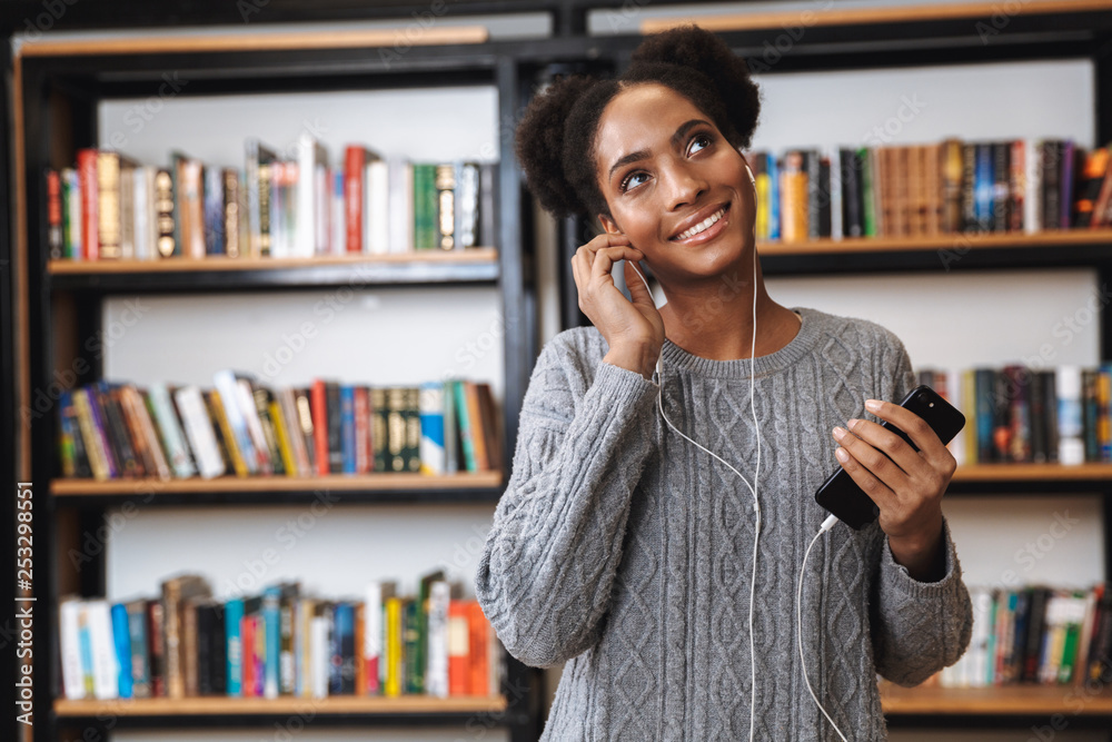 Happy young african student girl studying at the library Happy young african student girl studying at the library