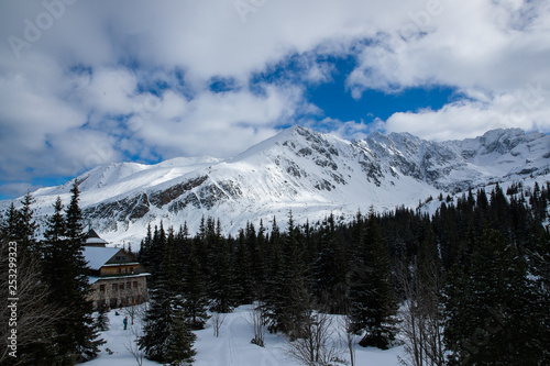 View on top of the mountains in the Zakopane area in Poland covered with fresh snow on the day with blue sky