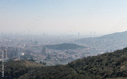 Photography Overview of the polluted city of Barcelona, from the Collserola mountain, with a layer of smog over it
