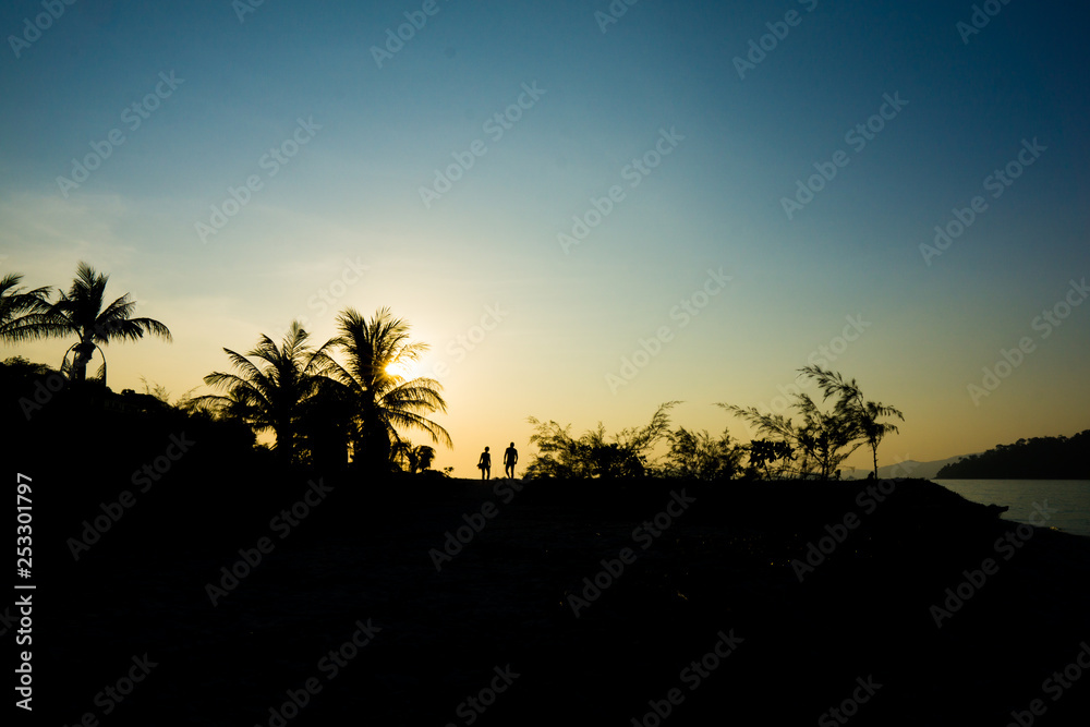 Scenery of sunset, forest of island and traveler silhouette