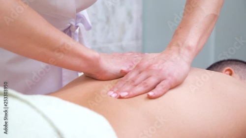 Wallpaper Mural female hands doing relaxing back massage for male customer in spa salon Torontodigital.ca