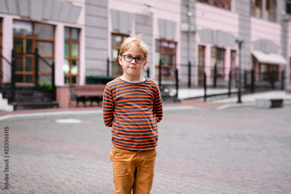 Young elementary boy with blonde hair and glasses