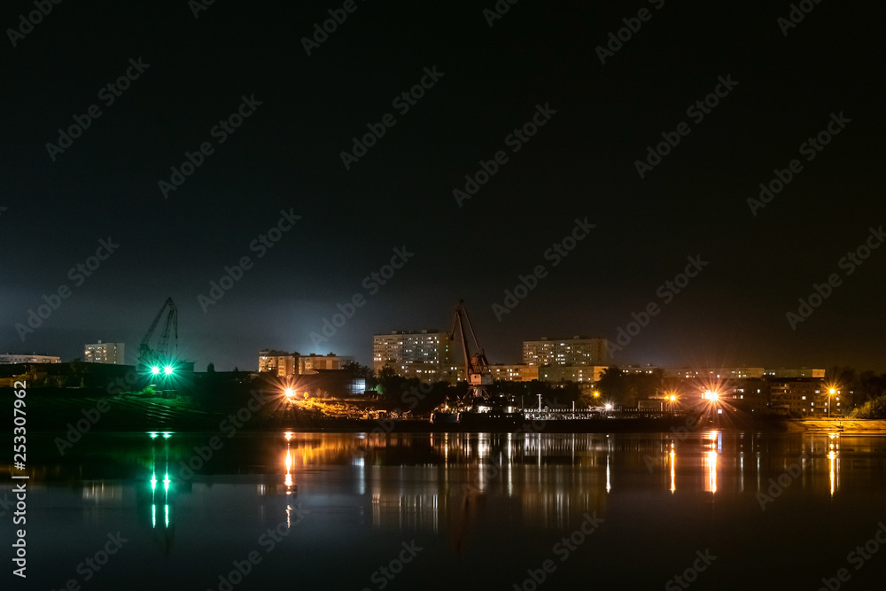 River port in the industrial area of the city at night. Urban landscape.
