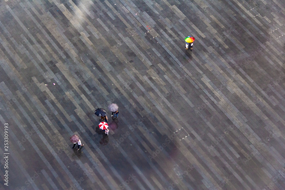 looking down of people hiding under their umbrellas
