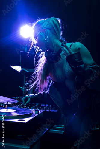 blonde stylish dj girl touching dj mixer in nightclub © LIGHTFIELD STUDIOS