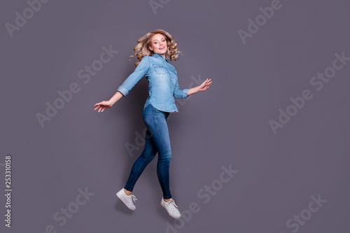 Full length body size profile side view portrait of her she nice cute charming lovely attractive carefree cheerful wavy-haired lady having fun isolated over gray purple violet pastel background